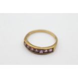 9ct gold amethyst fronted band ring - weighs 2 grams . Set with amethysts in a channel setting. Uk