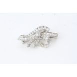 A 1950’s diamond set ribbon brooch with an estimated2cts of 8 cut diamonds and baguette diamonds.