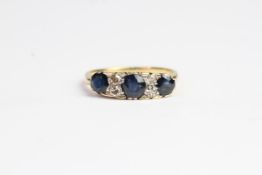 Antique 18 CT gold sapphire and diamond ring. Set with alternating sapphires and old cut diamonds.