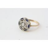 A vintage sapphire and diamond ring, detailing a star witha central diamond inset. The outer edge