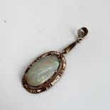 Antique 9ct gold and large opal pendant. The opal is articulated within the bamboo frame . Measuring
