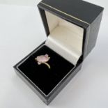 Fine 9CT gold rose quartz ring. Set with a marquise shaped rose quartz cabochon stone and two pink