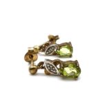 Fine 9ct gold peridot and diamond dangly earrings. Marked 376 for 9ct gold. Set with peridot and