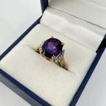Fine 9ct gold amethyst and diamond ring. Set with a amethyst in the center with diamonds either