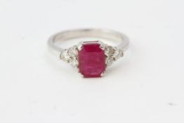 White gold ruby and diamond ring. The central ruby is set between 6 round cut diamonds, 3 on each