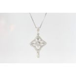 Suspended on a 9ct white gold chain (43cm/17 inches) an18 carat gold diamond pendant made of round