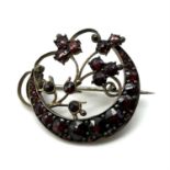 Antique bohemian cut natural garnet crescent moon brooch . Set in garnet gold. Measures 3cm wide.