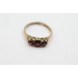 9ct gold garnet ornate framed ring. Weighs 3.1 grams. Set with three garnets in a trilogy design.