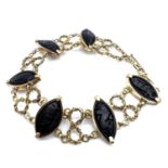 Fine heavy 18ct gold and carved whitby jet panel bracelet. Each panel is marquise shaped and crudely