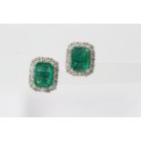A pair of emerald cut emerald and diamond earrings. Emeralds 2.95 carats total diamonds 0.95 carats.