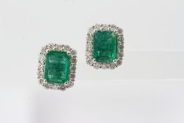 A pair of emerald cut emerald and diamond earrings. Emeralds 2.95 carats total diamonds 0.95 carats.