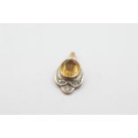 9ct gold diamond framed citrine pendant weighs 1.2 grams . Set with a citrine in the center and