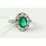 Fine platinum and emerald diamond cluster ring. Set in platinum marked PLAT . The head of the ring