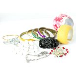 Vintage collection of costume jewellery, including bangles and necklaces and a brooch.