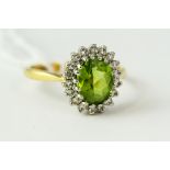 Fine 18ct gold peridot and diamond cluster halo ring. Uk size N . Weighs 4.4 grams .