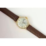 9CT LADIES MANUAL WIND OMEGA, Silver sunburst dial. 18mm gold case. On a omega leather strap with