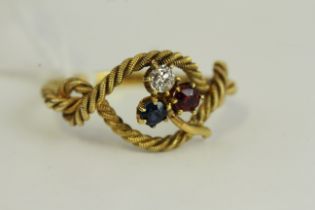 Antique high carat gold shamrock knott ring set with a sapphire, ruby and diamond. Weighs 2.7