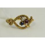 Antique high carat gold shamrock knott ring set with a sapphire, ruby and diamond. Weighs 2.7