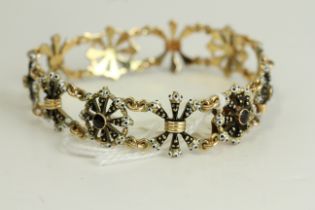 Fine 14ct gold and enamel Blackmore bracelet. Set with garnets in 14ct gold with black and white