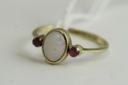 Fine 9ct gold opal and ruby ring, set in 9ct gold marked with a natural opal, flanked with a ruby