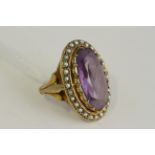 Antique yellow metal seedpearl and amethyst ring. Set in yellow metal with natural seedpearls and an