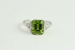 Platinum Peridot & Diamond Ring. Emerald cut Peridot is Claw-set Between Pave-set Diamond Kite