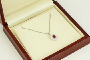 Fine 18ct white gold diamond and ruby cluster necklace, set with diamonds surrounding a ruby, hung