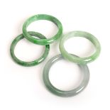 GROUP OF FOUR JADE BANGLES