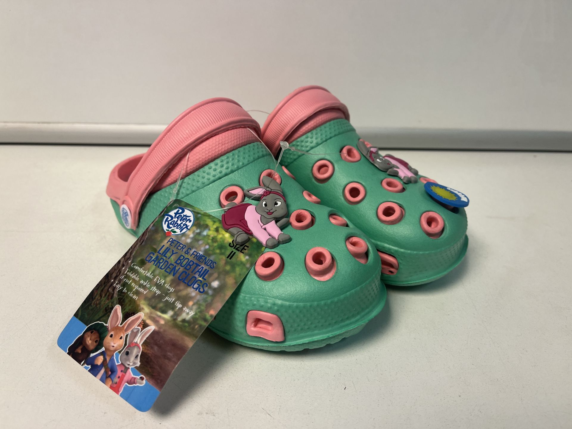 12 X NEW PAIRS OF PETER RABBIT & FRIENDS LILY BOBTAIL GARDEN CLOG CHILDRENS SHOES. SIZES MAY VARY.