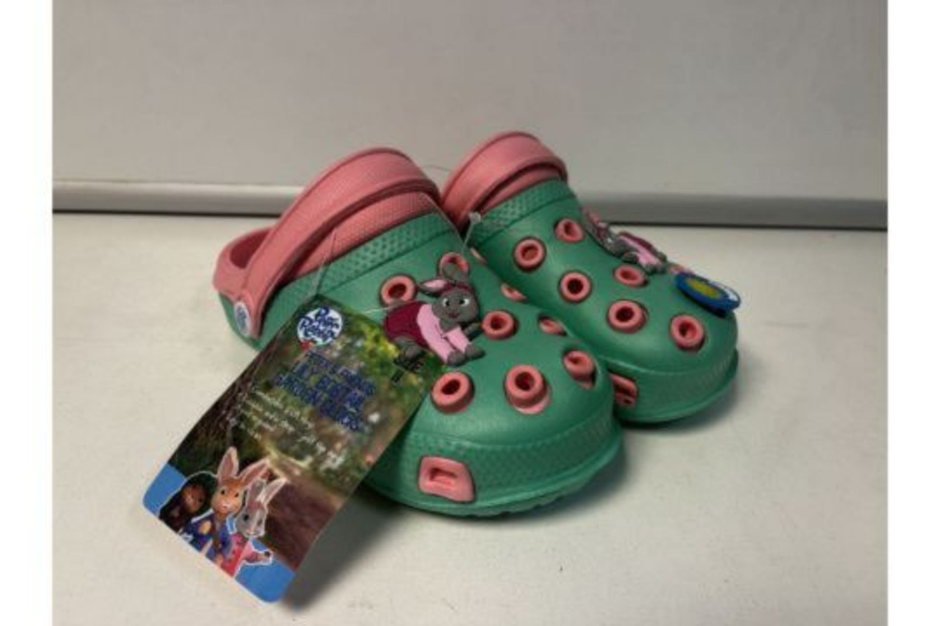 18 X NEW PAIRS OF PETER RABBIT & FRIENDS LILY BOBTAIL GARDEN CLOG CHILDRENS SHOES. SIZES MAY VARY.