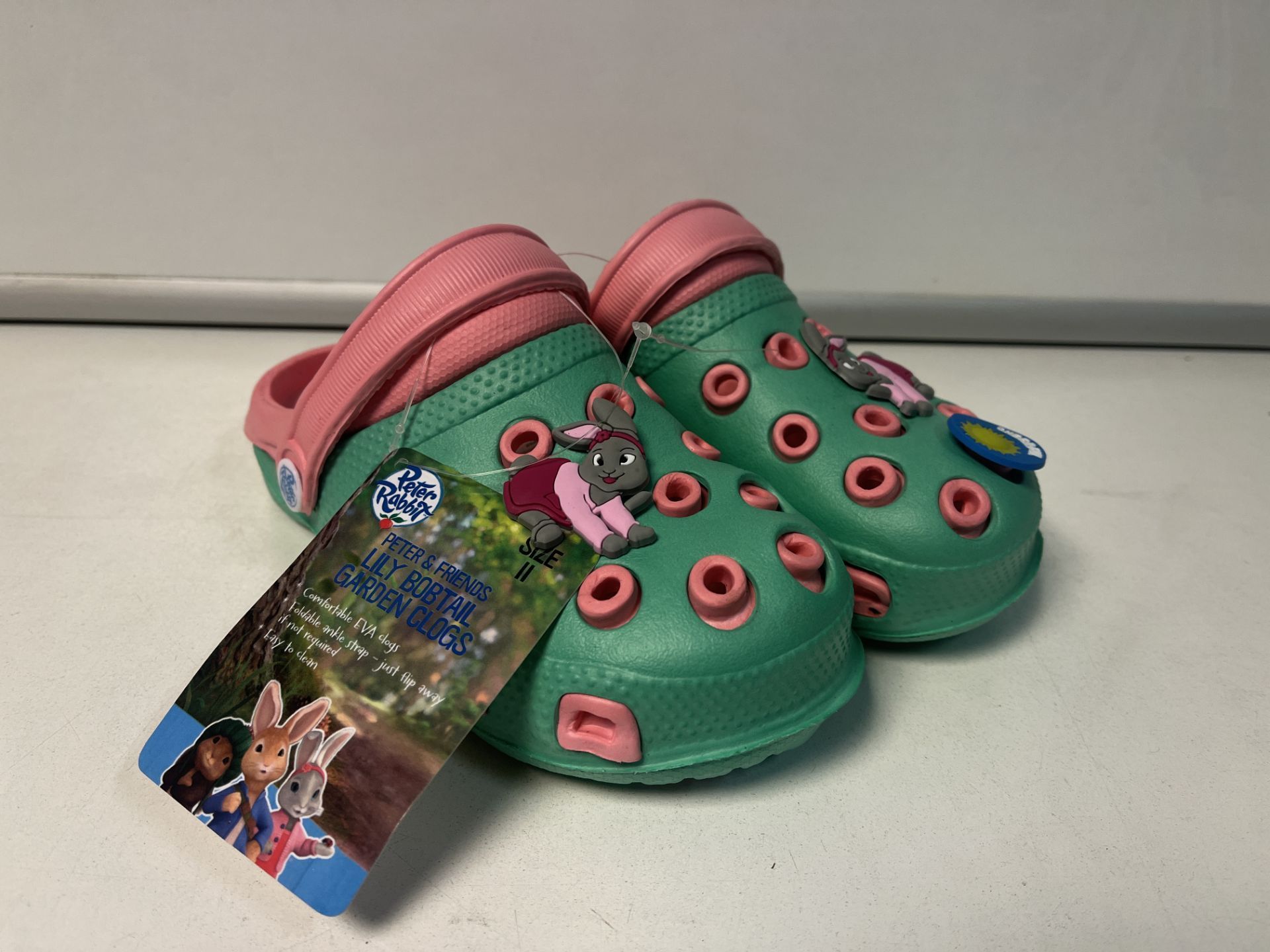 12 X NEW PAIRS OF PETER RABBIT & FRIENDS LILY BOBTAIL GARDEN CLOG CHILDRENS SHOES. SIZES MAY VARY.