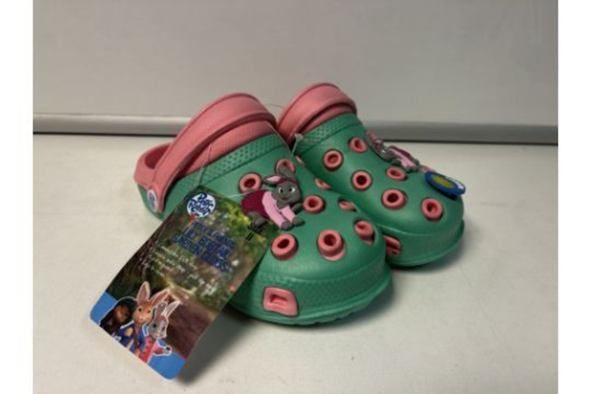 12 X NEW PAIRS OF PETER RABBIT & FRIENDS LILY BOBTAIL GARDEN CLOG CHILDRENS SHOES. SIZES MAY VARY.