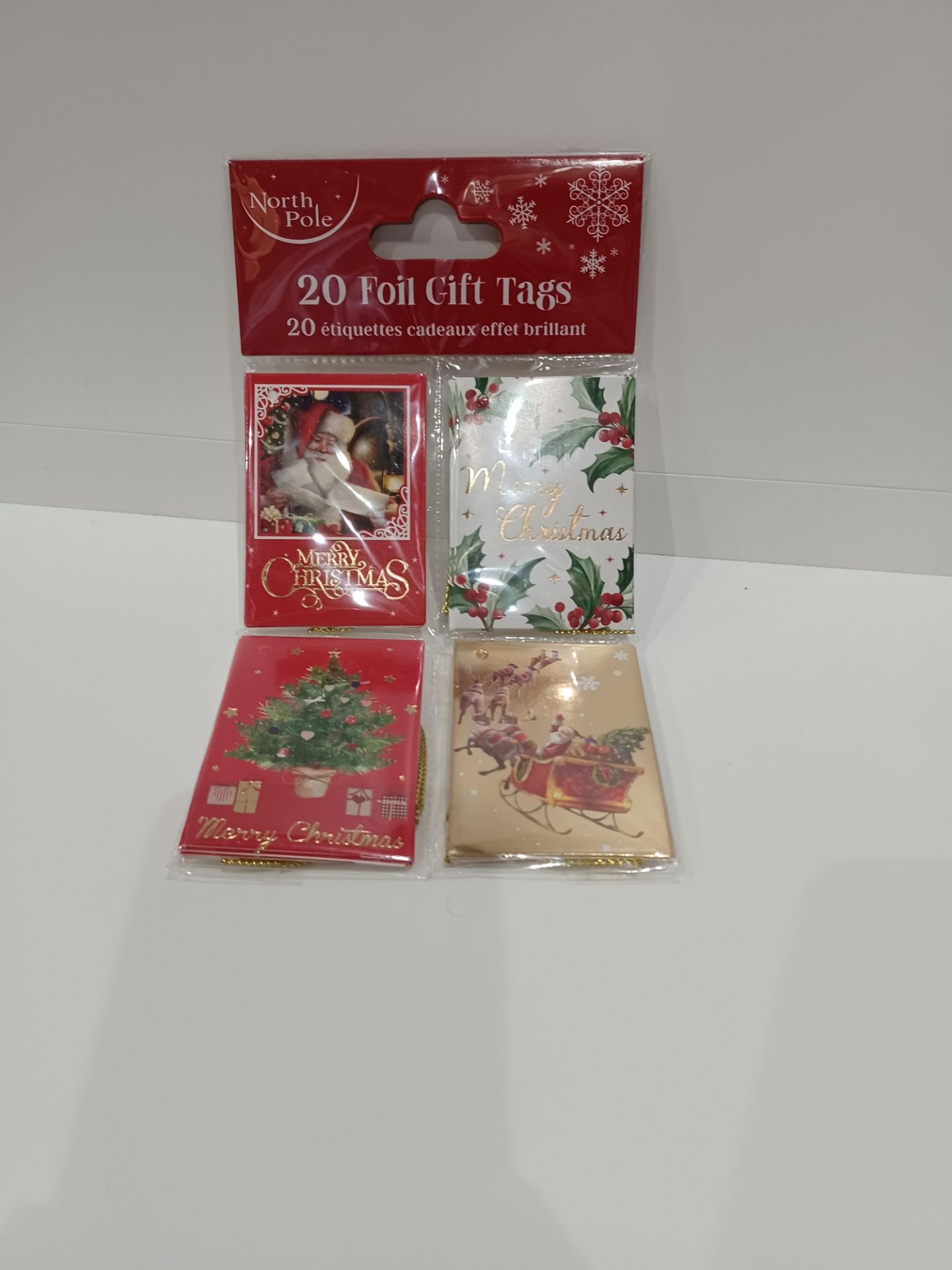 108 X NEW PACKAGED PACKS OF 20 NORTH POLE FOIL GIFT TAGS. ROW 15 B/W
