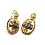 A pair of antique English, 15 carat gold earrings; with applied designs decorated with blue enamel &