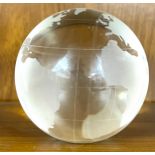 Hand etched glass paperweight globe features Earth's land features etched onto the crystal clear