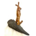 Wooden sculpture depicting human form, on slate base, approximate length of slate base 16 inches,