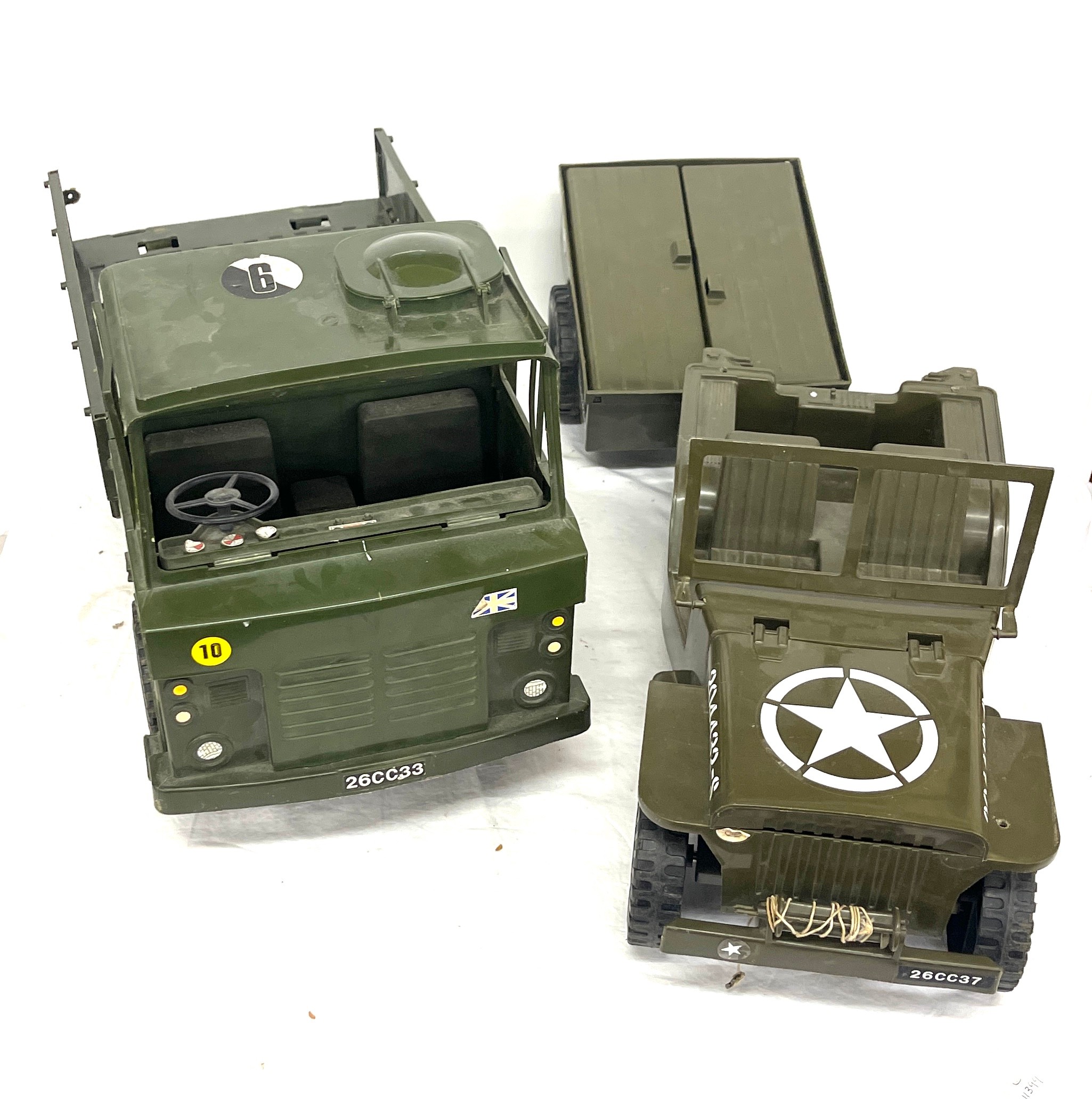 2 Vintage Army trucks, both plastic, largest truck measures approximately 56 x 28cm