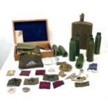Large selection of assorted military items includes shells, cloth badges etc