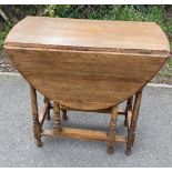 Oak gate leg table measures approx 30" wide 40" depth (open) 15" depth (closed) 28" tall