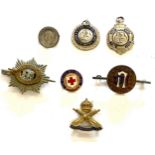 Selection of vintage cap badges, medals, to include a silver badge etc