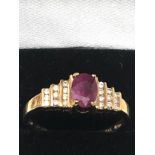 9ct gold ruby & diamond ring central ruby measures approx 7mm by 5.5 with diamonds either side