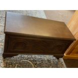 Carved blanket box of casters measures approx height 20 inches by 39inches width and 19 inches depth