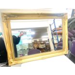 Gilt framed mirror, measures approx 35 inches wide 25 inches tall