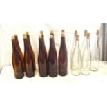 Ten Brown Vintage wine bottles with corks and five clear vintage wine bottles with corks
