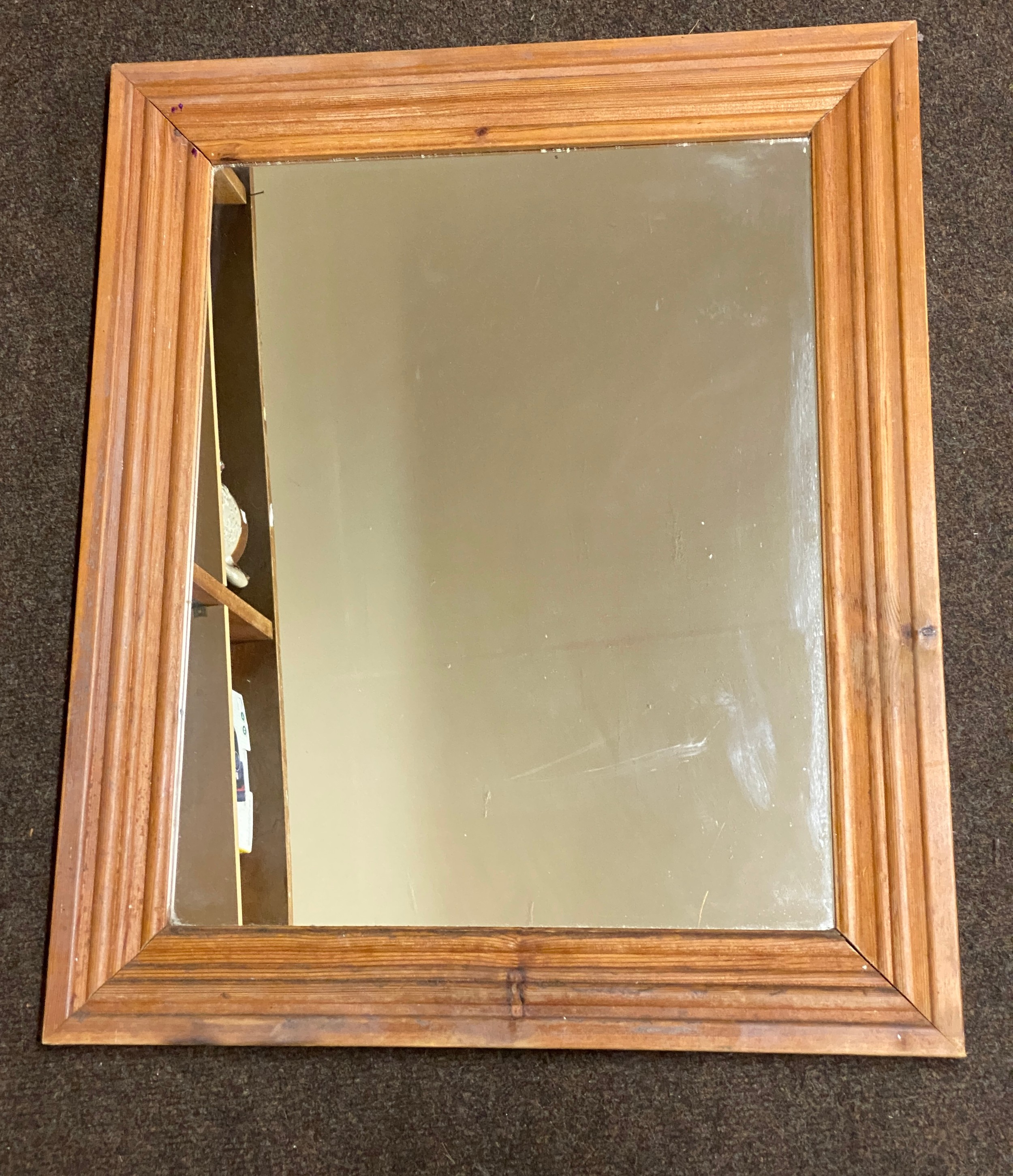 Pine framed mirror measures 25 inches by 21 inches