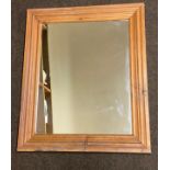 Pine framed mirror measures 25 inches by 21 inches