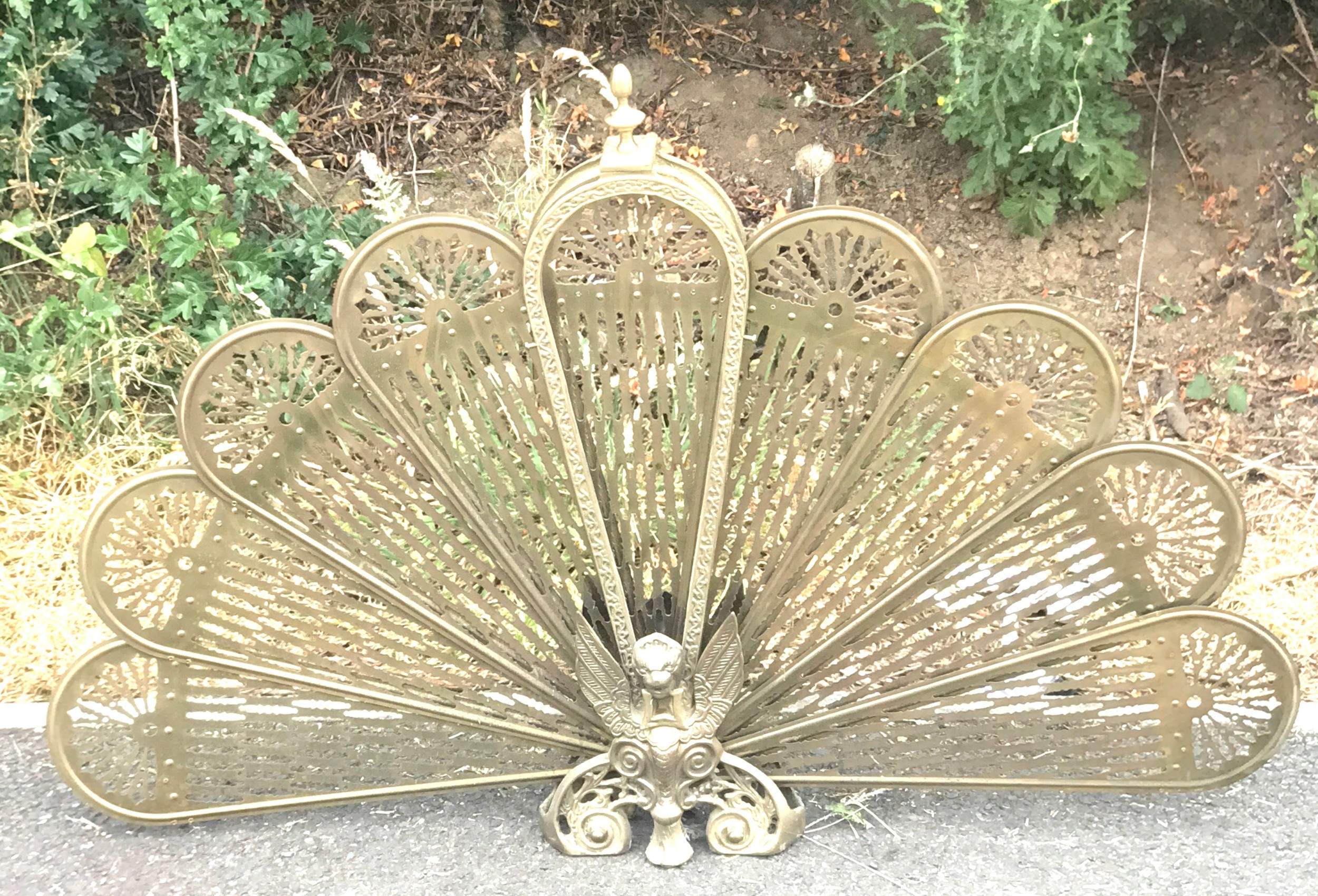 Vintage Brass Peacock firescreen, approximate height 25 inches, width when fanned out 38 inches