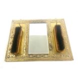 1940s mirror and brushes on brass frame measures approx 39cm wide 29cm tall