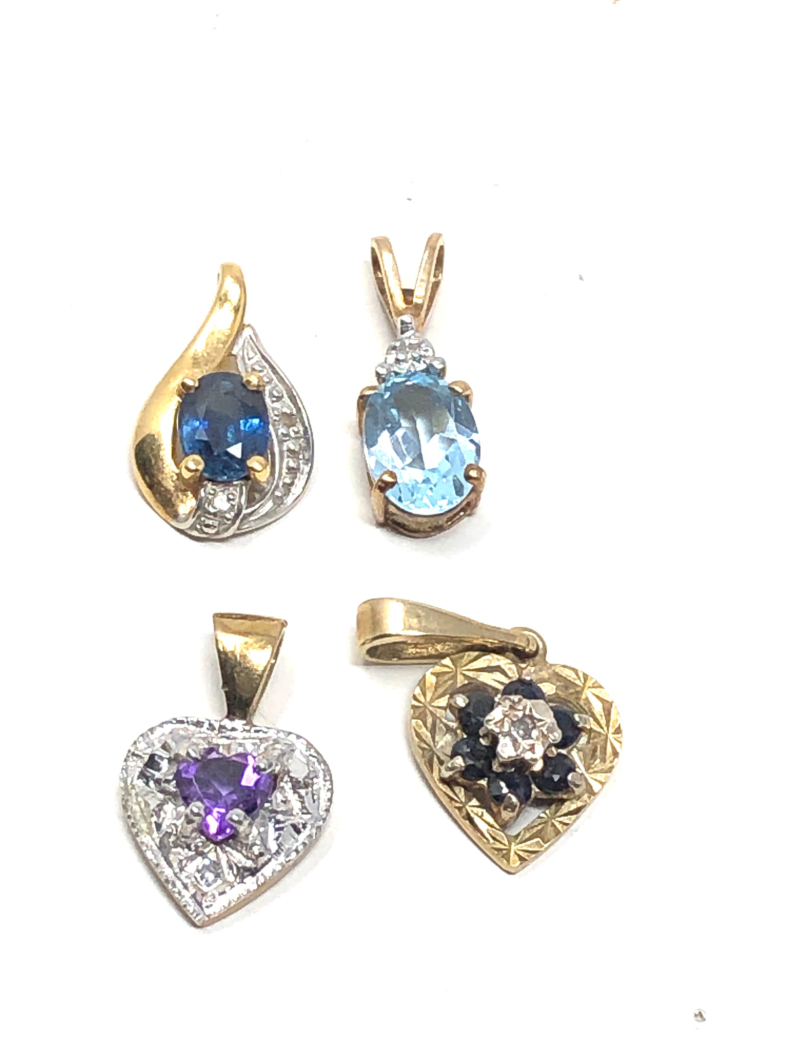 4 x 9ct gold gemstone & diamond set pendants inc. sapphire, topaz & amethyst (2.6g)