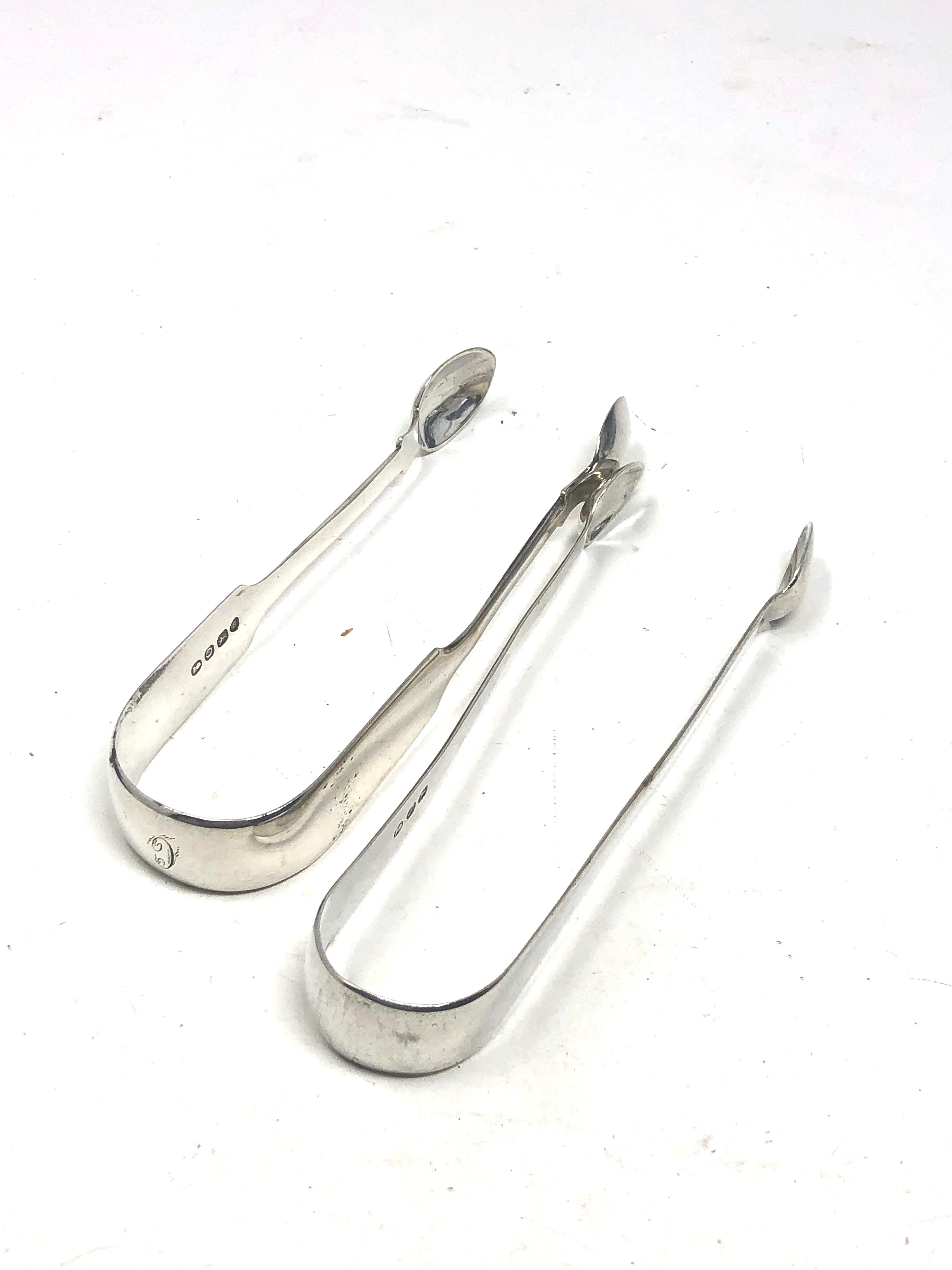 2 antique silver sugar tongs